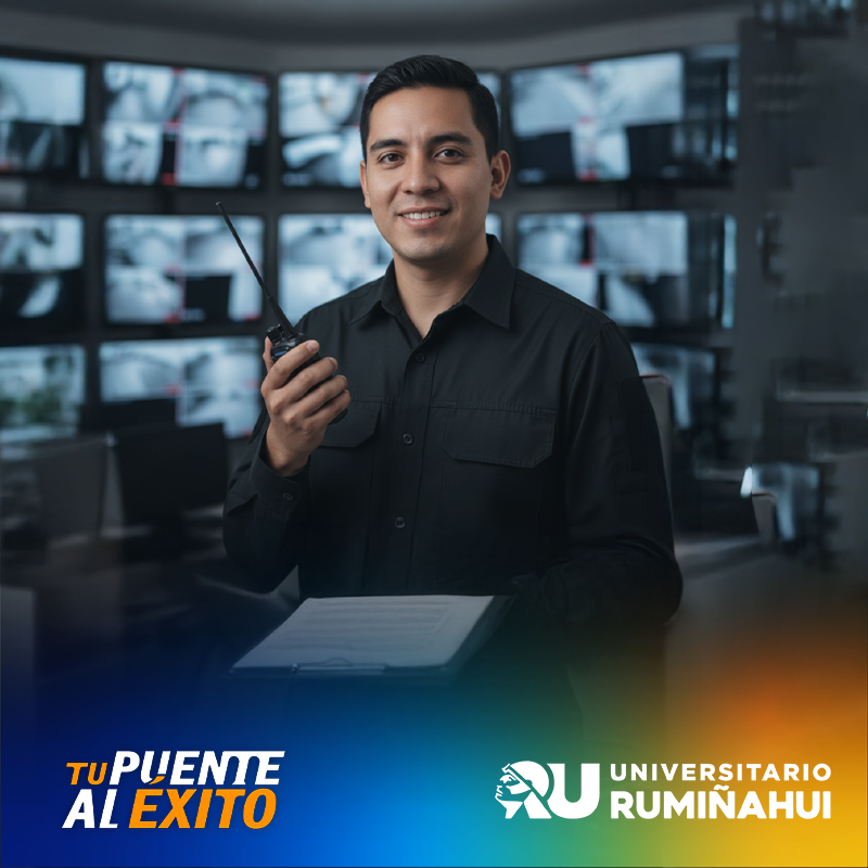 Smiling man in a black shirt holds a walkie-talkie in a busy control room with many monitors behind him, university branding in the corner.