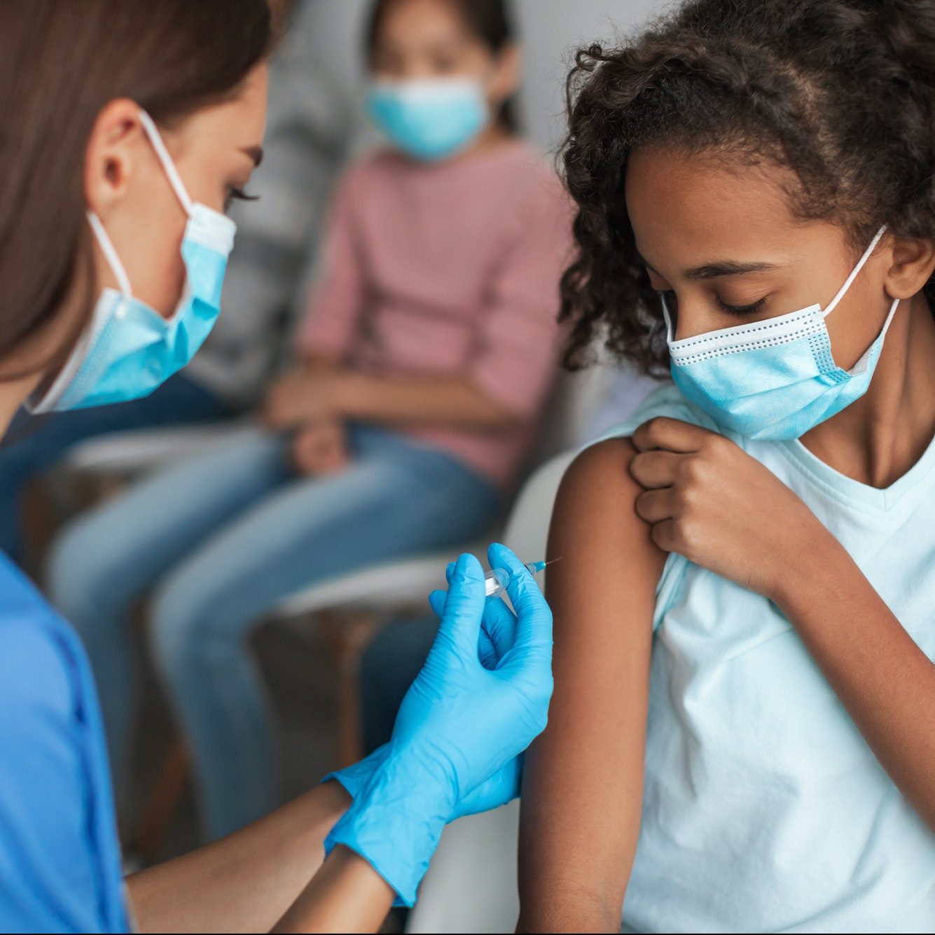 Nurse Vaccinating Black Preteen Girl Injecting Vaccine Against Covid-19 Indoors - Tecnológico Universitario Rumiñahui Nurse Vaccinating Black Preteen Girl Injecting Vaccine Against Covid-19 Indoors